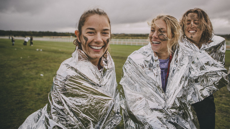 athletes in emergency blankets after race