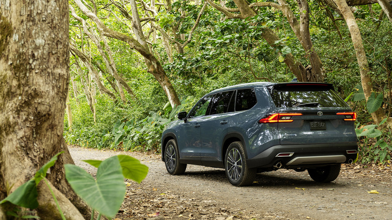 2024 Toyota Grand Highlander driving on a trail in the woods