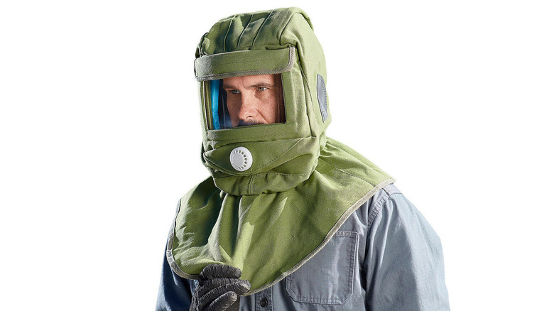 A man wearing a blasting hood
