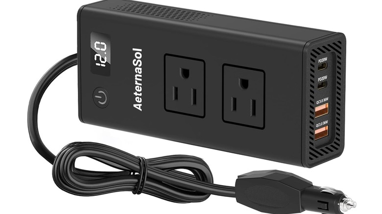 Stock photo of a black power outlet strip with car adapter