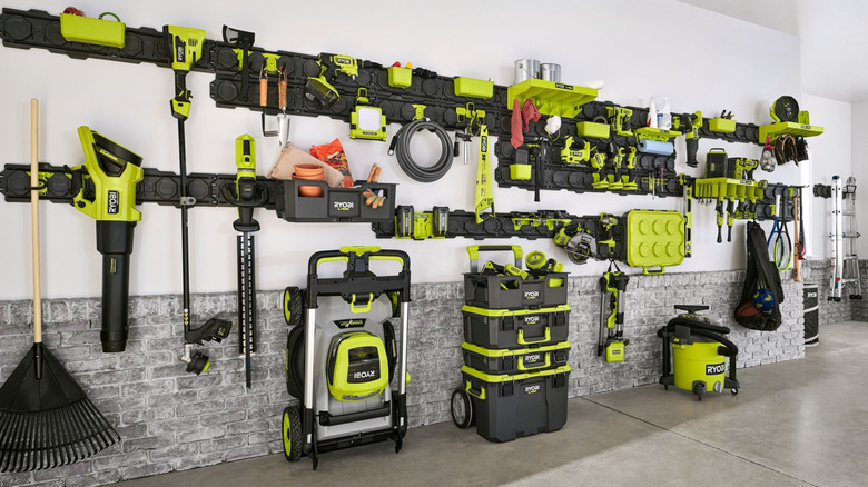 A white wall with many Ryobi tools attached to it