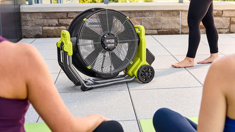 people doing yoga near Ryobi misting air cannon