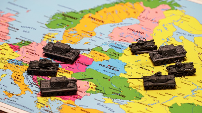 Toy tanks arranged on a world map