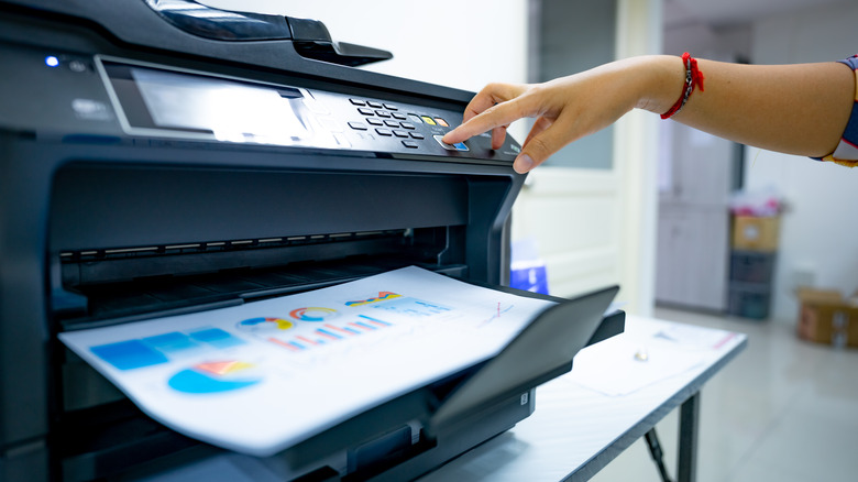 Woman pressing printer