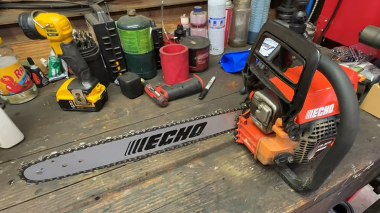 Echo chainsaw on a work table with some other tools