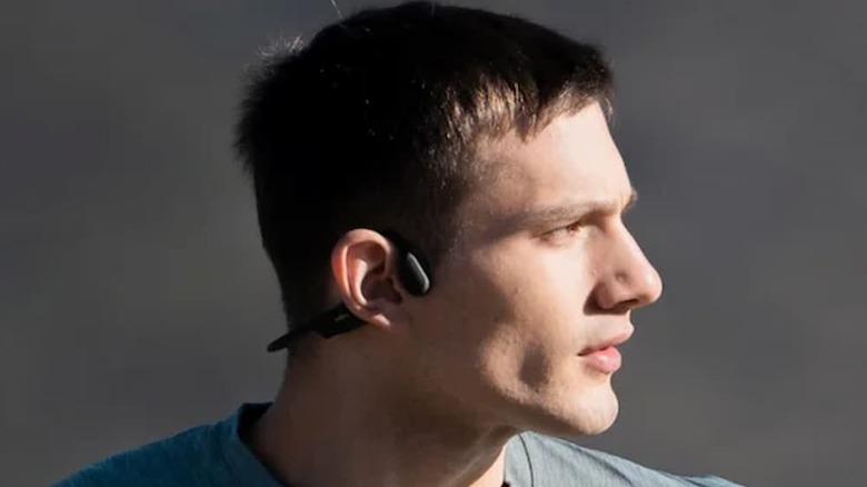 A man running with Shokz OpenRun Open AR Bluetooth Wireless Headphones on.