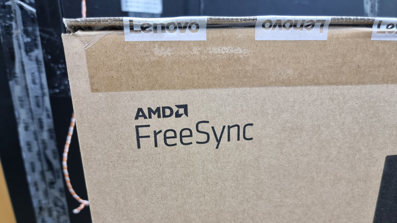 AMD FreeSync shown on a cardboard box, packaged with Lenovo brand taping