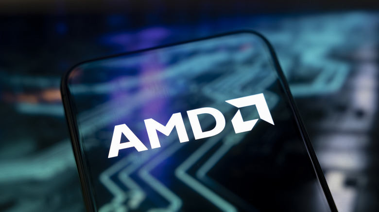 The AMD logo on a transparent phone screen in front of a stylized background