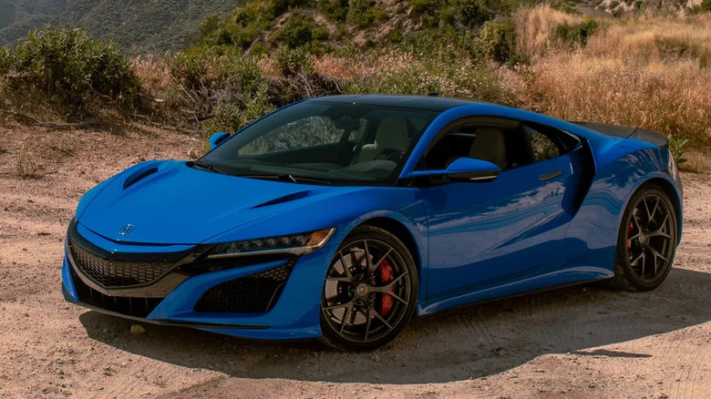 blue Honda Acura NSX on dirt