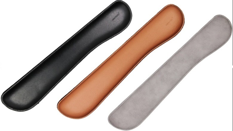 A series of identical leather wrist rests in black, tan, and gray