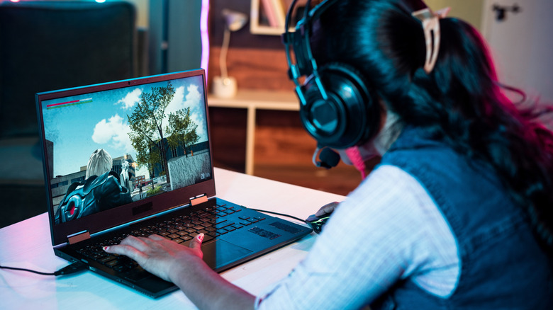 A person playing a game on a laptop