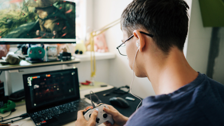 A person using a controller with a laptop