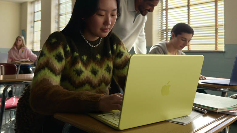 A student using the Citrus-colored MacBook Neo in class.