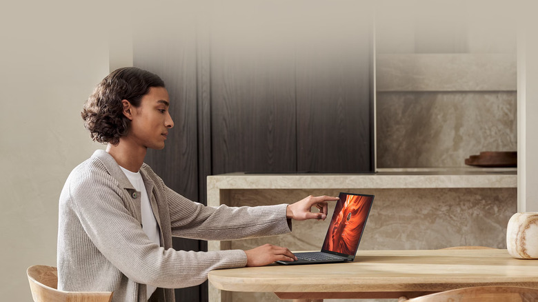 A man working on the Asus Zenbook S 14 at home.