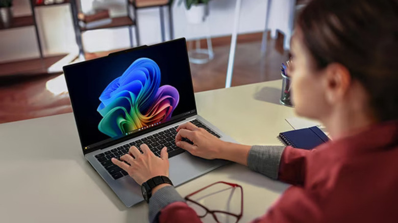 A woman typing on the Lenovo ThinkPad X9 14 Aura Edition.