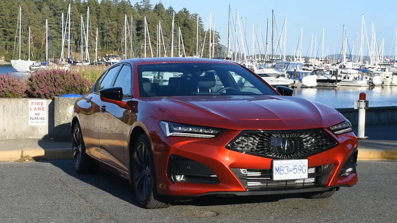 A red Acura TLX parked