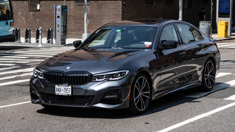 A gray BMW 3 Series driving