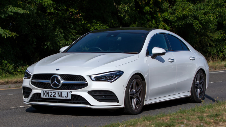 A White Mercedes-Benz CLA driving
