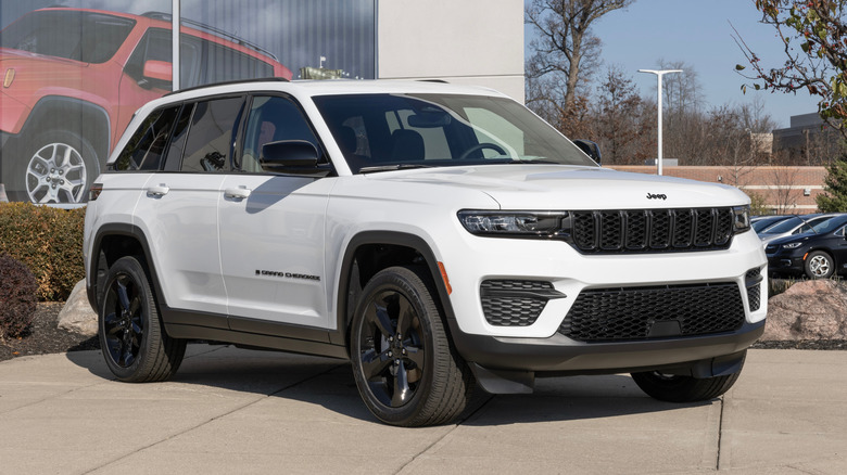 A white Jeep Grand Cherokee parked