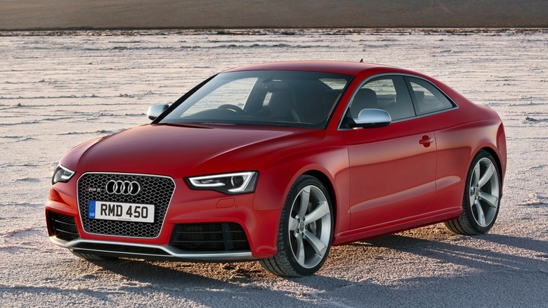 Red 2012 Audi RS5 Coupe on a salt lake front 3/4 view