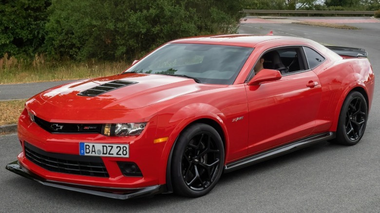 Red Chevrolet Camaro Z/28 parked on a road