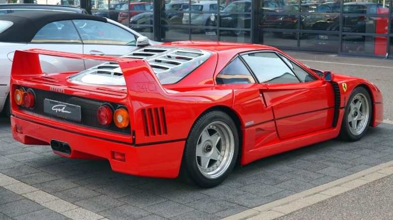 Red Ferrari F40 parked at a car museum