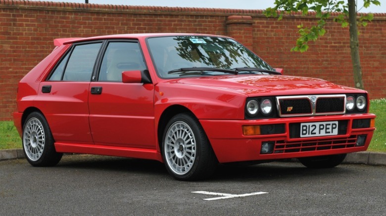 Red Lancia Delta Integrale Evoluzione parked in front of brick wall