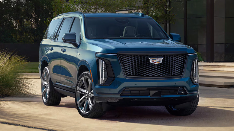 A blue Cadillac Escalade on a driveway