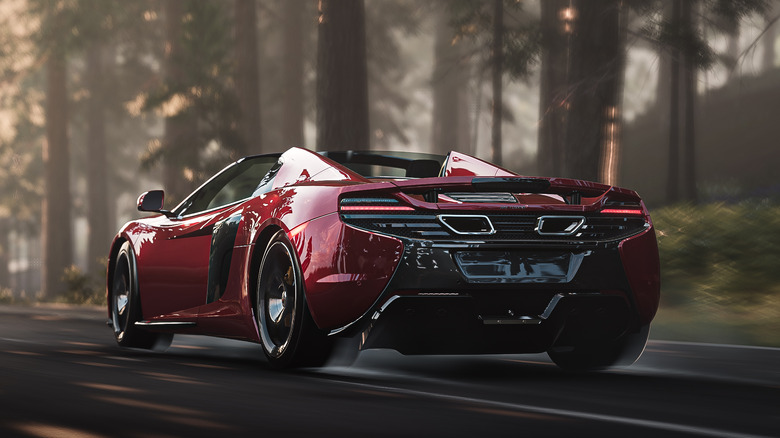 Maroon McLaren sports car driving through forest in Forza 4 videogame