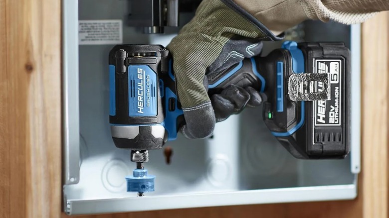 drilling hole in service box with Hercules impact driver