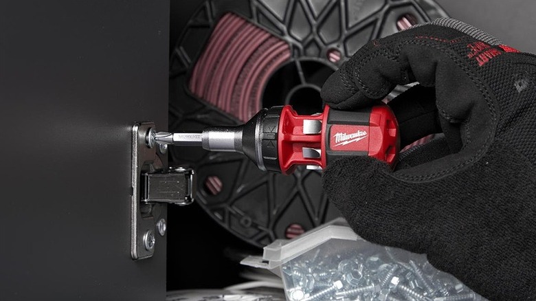 Using a multi-bit screwdriver to work with a fastener.