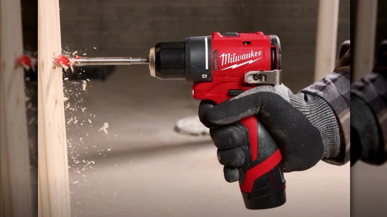 Using a Milwaukee drill/driver in a piece of wood.