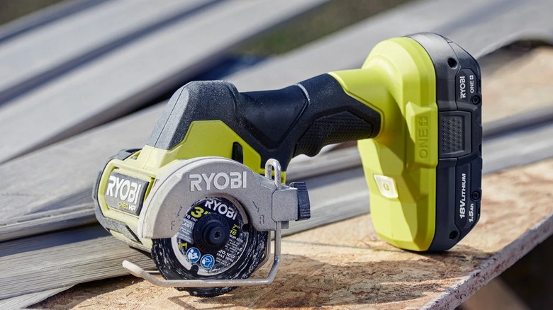 Ryobi 18V One+ HP Compact Brushless Cut-Off Tool resting on a particle board surface