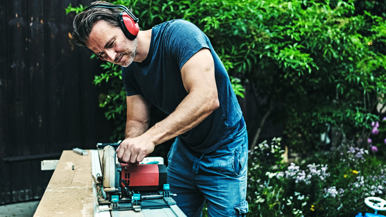 Man using a circular saw working outside