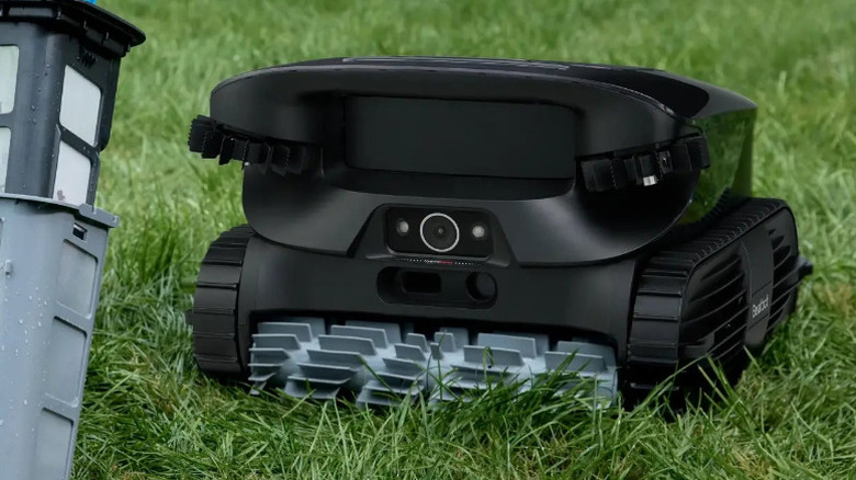 Beatbot AquaSense X on grass next to its filter.