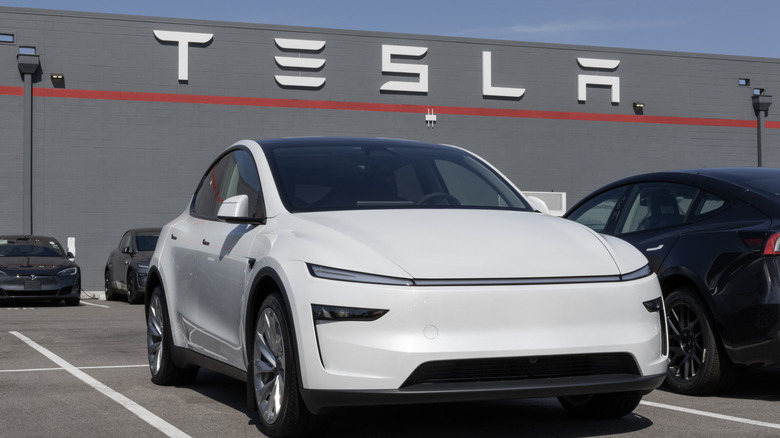 A white Tesla Model Y on display at a dealership