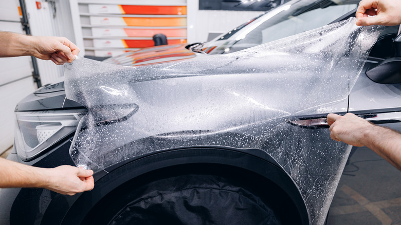 A PPF coating being applied on a car