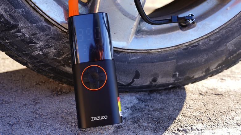 A portable tire inflator filling up air in a vehicle