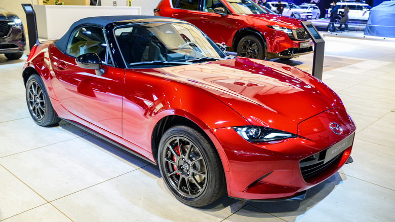 Red MX-5 in a dealer showroom