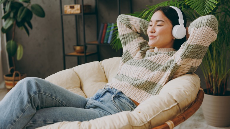 Young woman listening at home with headphones