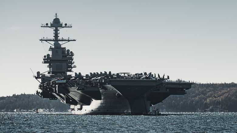 An aircraft carrier anchored off the coast