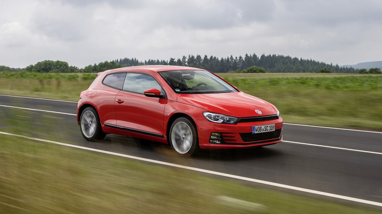 VW Scirocco driving down a road