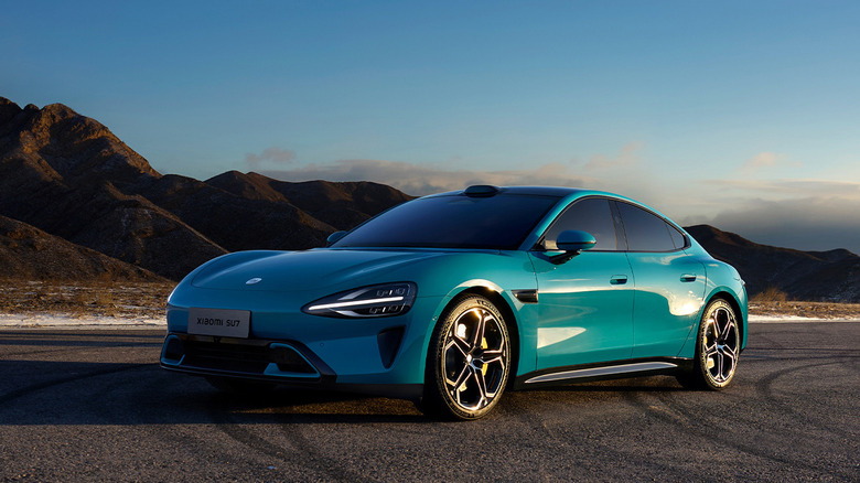 Xiaomi SU7 electric sedan front 3/4 view with mountains behind