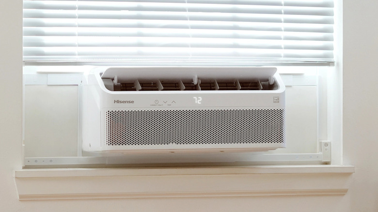 A Hisense Smart Inverter Window Air Conditioner in a window.