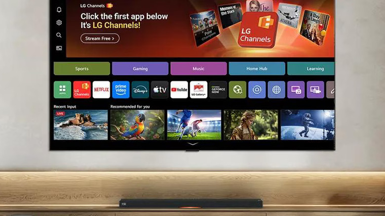 LG C6 TV mounted to wall and turned on with soundbar beneath it.