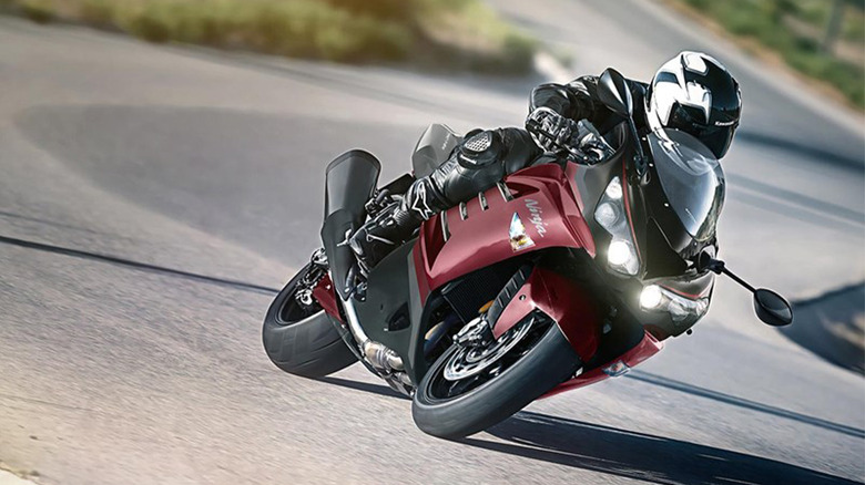 A person riding a Kawasaki ZX-14R around a corner