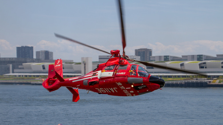Red AS 365 Dauphin in flight