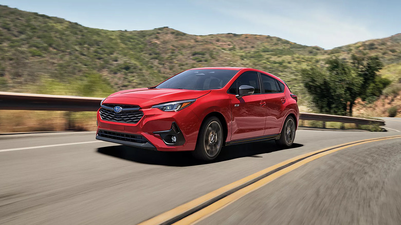 A red Subaru Impreza driving