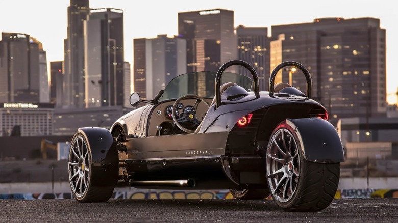 Black Vanderhall Venice GTS parked with city skyline in the background