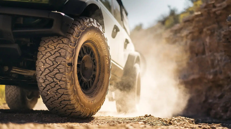 A car with the BFGoodrich All-Terrain T/A KO3 all-terrain tires on a dirt surface